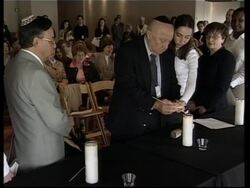 Candles lit at Holocaust memorial service News Clip