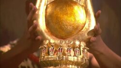A pair of hands places a gold crown with wings on a Cleopatra's head. Stock Footage