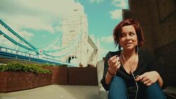 Woman calling at the phone by the Tower Bridge Stock Footage