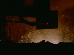 CU TS Shot of Mechanical arm moving away from blasting furnace while holding glowing rod Stock Footage
