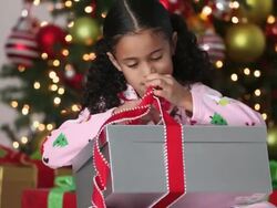 MS TU Excited Young Girl Opening Christmas Present / Richmond, Virginia, USA Stock Footage