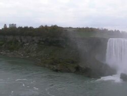 Wide Shot pan-left zoom-out - Water cascades over Niagara Falls / Ontario, Canada Stock Footage