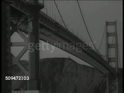 1936: U.S. BRIDGES: LA MS Arched bridge. LA MS Golden Gate Bridge, San Francisco, California. HA WS Highway bridge. LA MS Billboard 'PWA Federal Emergency Admin of Public Works.' LS Florida overseas highway bridge, tropical trees FG. FDR's New Deal Instructional Video