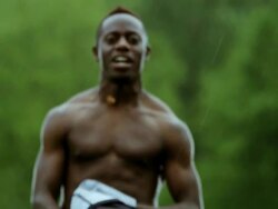 MS SLO MO TD R/F professional soccer player running towards camera taking shirt off after scoring goal Stock Footage