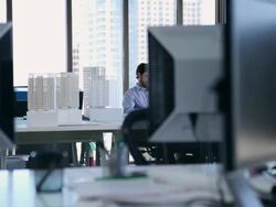 MS DS businessman sitting at table in office working on digital tablet Stock Footage