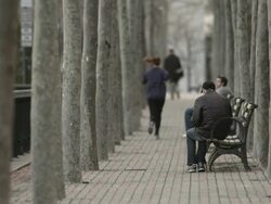 A women running by some park benches. Stock Footage