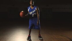 A male basketball player dribbles a ball on a gym court and then drops the ball and walks away. Stock Footage
