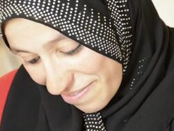 Two Syrian women refugees from Syrian Civil War, one holds infant Stock Footage