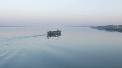 Sunset and twilight are reflected in the calm glassy flat River Jamuna in Northern Bangladesh Stock Footage