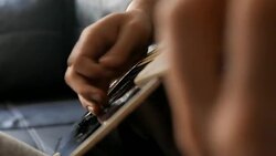 Guy playing chords on a black acoustic guitar Stock Footage
