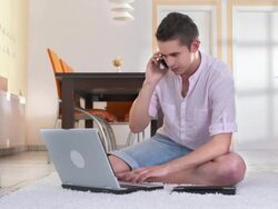 HD DOLLY: Young Man Using Phone, Laptop And Tablet Stock Footage