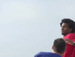 A group of guys playing flag football on the beach. - Slow Motion Stock Footage