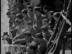 1942: U.S. MARINES: NAVY CONVOY: WS Marines, sailors on deck, congregating, smoking. HA VS Soldiers looking over railing of Navy ship, men w/ helmet, headphones, Navy caps leaning on railing. MS Men manning ship cannon. Sea power, military, USA, WWII Instructional Video