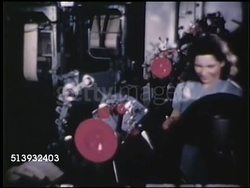 1950: FIRESTONE TIRE FACTORY: COLOR:  WS Female plant workers attaching high grade rubber coated steel wire to wheels. MCU Machine spinning, attaching reinforcement coating. Instructional Video