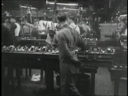 Factory workers assemble parts. News Clip