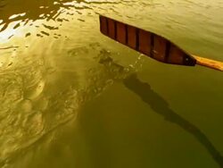 Slow motion close up oar of rowboat moving through water of Ganges River / Varanasi, India Stock Footage