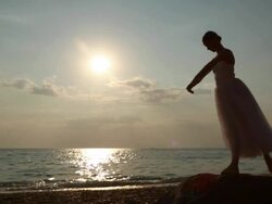 Ballerina at sunset on the coast Stock Footage