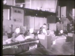 1950s: UNITED STATES AIR FORCE ACADEMY: VS Radio operators in map room, large map of USA w/ lights, arrows, male picking up telephone, general in office on telephone. EXT VS Cadets scrambling to bomber aircraft, climbing up ladder. Instructional Video