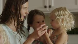 Close up slow motion panning shot of mother and daughters baking cookies / Orem, Utah, United States Stock Footage