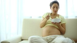 Pregnant woman eating salad. Stock Footage