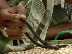 Man's handusing prayer beads Stock Footage