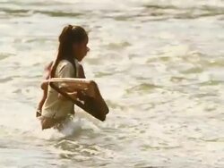 MS TS SLO MO Shot of two children crossing river / Muang Ngoi, Luang Prabang, Laos Stock Footage