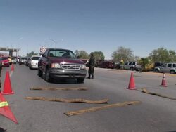 April 9 2009 MS PAN Mexican Soldier letting in cars at Mexican and US border, Juarez, Chihuahua, Mexico, AUDIO Stock Footage