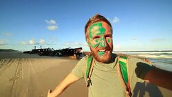 Young man on Fraser Island takes selfie portrait with shipwreck Stock Footage