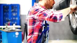 Car mechanic working under a vehicle. Stock Footage