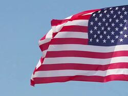 MS SLO MO Shot of American Flag Waving in Wind / Caen, Normandy, France Stock Footage