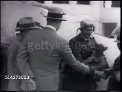 1933: AERONAUTICAL RACING: Aviator Colonel Roscoe Turner holding lion cub 'Gilmore' while shaking hands w/ men in front of aircraft, putting 'Gilmore' into cockpit.  [VO Roscoe saying Gilmore to clubs, best hotels, never wanted, loved him like dog.] Instructional Video
