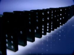 High Speed Dominoes - MCU side angled view, long row of dominoes fall over away from camera Stock Footage