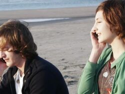 CU SLO MO Couple at beach talking on mobile phones / Isle of Palms, South Carolina, USA Stock Footage