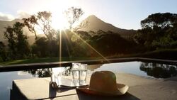 Swimming pool looking out to scenic mountain sunset Stock Footage