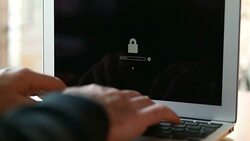 Computer hacker stealing data from a laptop Stock Footage