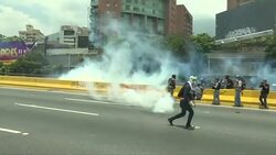 CLEAN : Police try to stop Venezuelan protests with gas News Clip