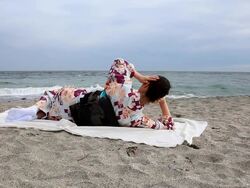 Japanese woman relaxing on beach Stock Footage