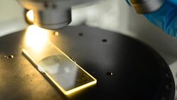 panning: adjust len for using microscopy slide under orange light Stock Footage