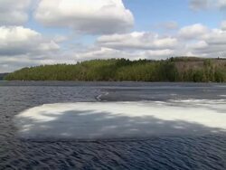 WS View of ice melting on lake Opeongo Algonquin park in spring / Whitney, Ontaria, Canada Stock Footage