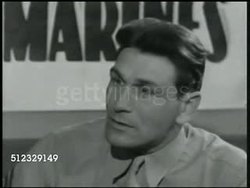 1942: U.S. MARINES RECRUITMENT: DRAMATIZATION: INT MS Young man enlisting in office. VS Man talking to officer at desk '... I want to fight.' 'What's your name?' 'Charlie Bulas.' CU Marine Corps ID card 'Charles Bulas.' (possible reprisal). Instructional Video