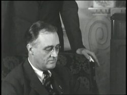 Franklin D. Roosevelt opens mail while Eleanor Roosevelt knits as their two boys stand near them. News Clip