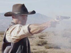Slow motion of cowboy lifting and shooting his pistol. Stock Footage