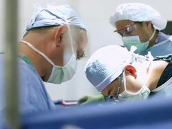 Doctors performing surgery in operating room Stock Footage