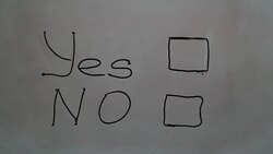 Hand writing a 'Yes' message on a white board using a black marker Stock Footage