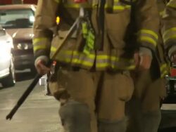 Fireman Walking From Firetruck Stock Footage