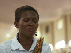 CU Shot of woman in white praying in church / Lagos, Nigeria Stock Footage