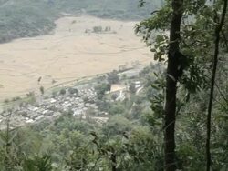 WS PAN HA village seen through jungle / Xam Neua, Laos Stock Footage