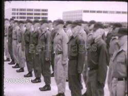 1963: UNITED STATES AIR FORCE ACADEMY: EXT VS Upper classmen, officers, supervising first year cadets standing at attention in Cadet Area, performing drills, officer watching, marching across w/ Cadet Cathedral building BG. Colorado, CO, Rampart Range Instructional Video