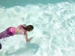 WS View of young girl pretending to be mermaid in pool / Lamy, New Mexico, United States Stock Footage