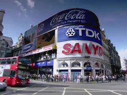 MS Intersection, tourists, and traffic in Piccadilly Circus / London, England, United Kingdom Stock Footage